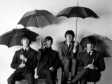 The Beatles with umbrellas, London, 1964. by ROBERT  WHITAKER